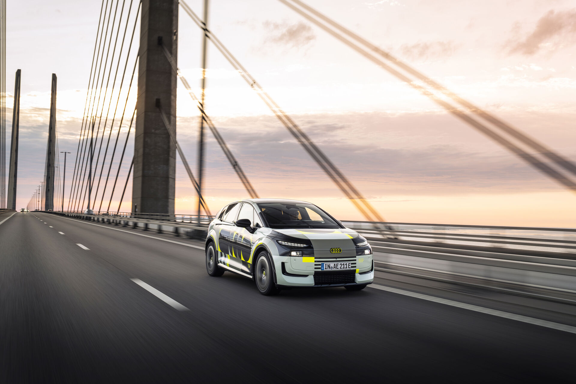 Official Audi image of the camouflaged A2 e-tron driving with its design livery.