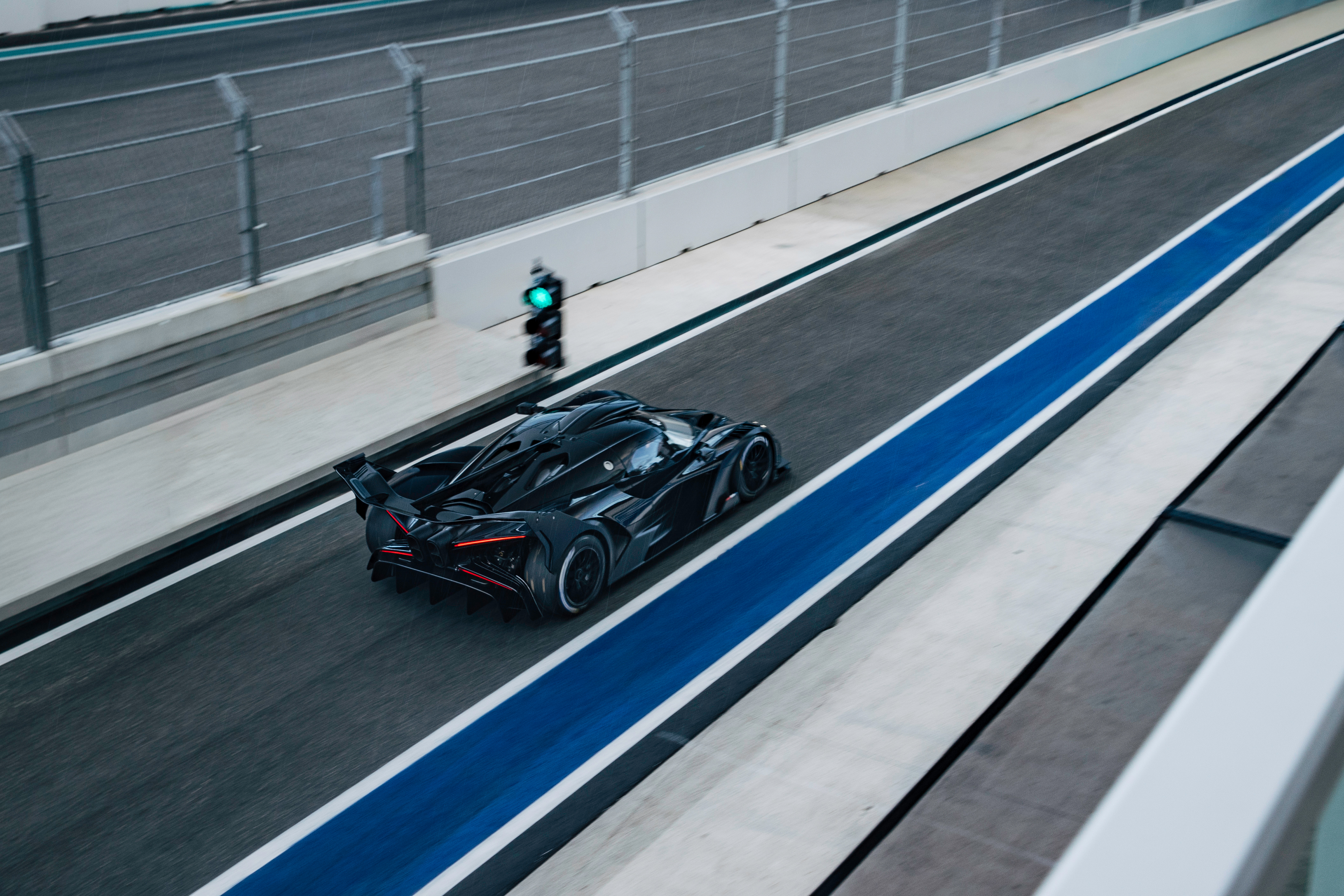 Official Bugatti Newsroom image of a black Bugatti Bolide on track at Miami International Autodrome.