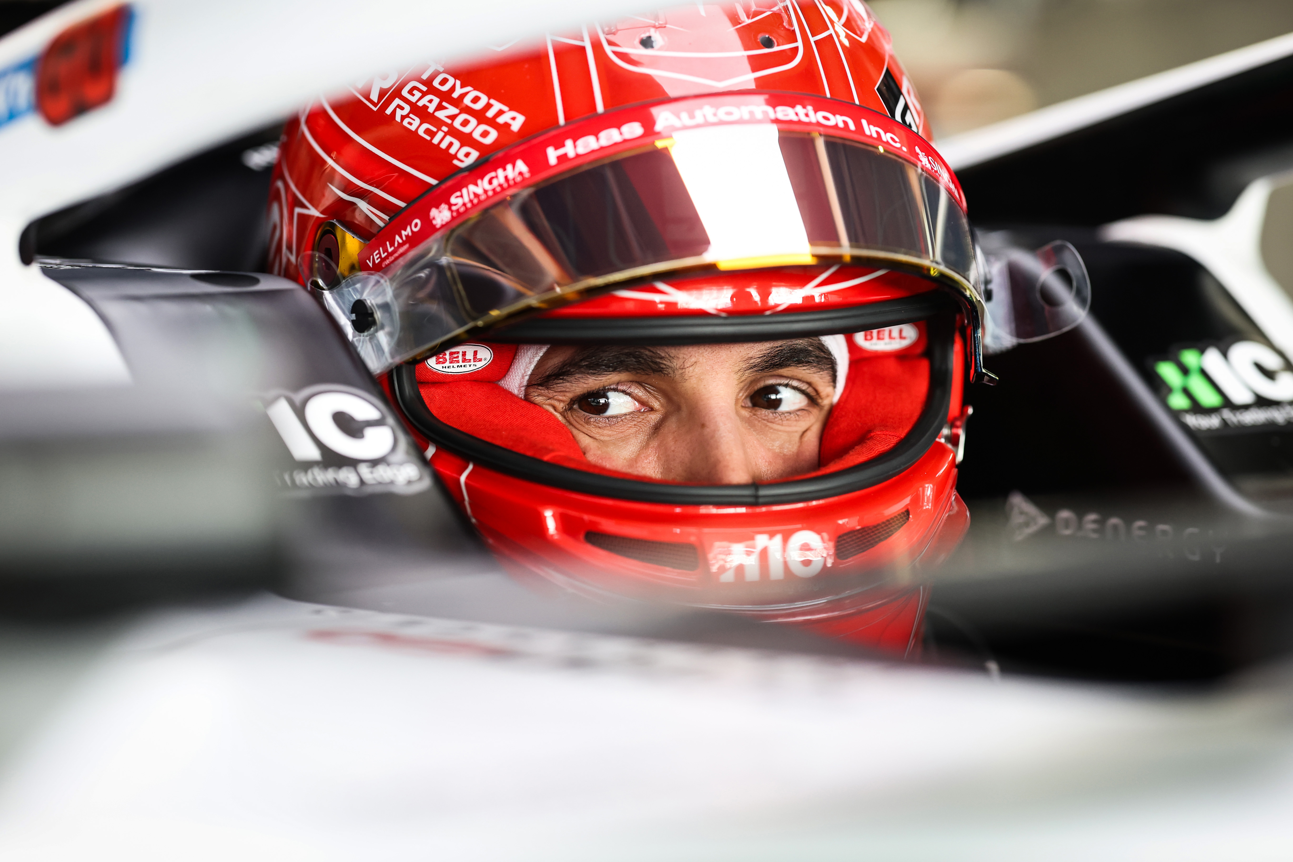 Esteban Ocon seated in the cockpit of the Haas VF-26.