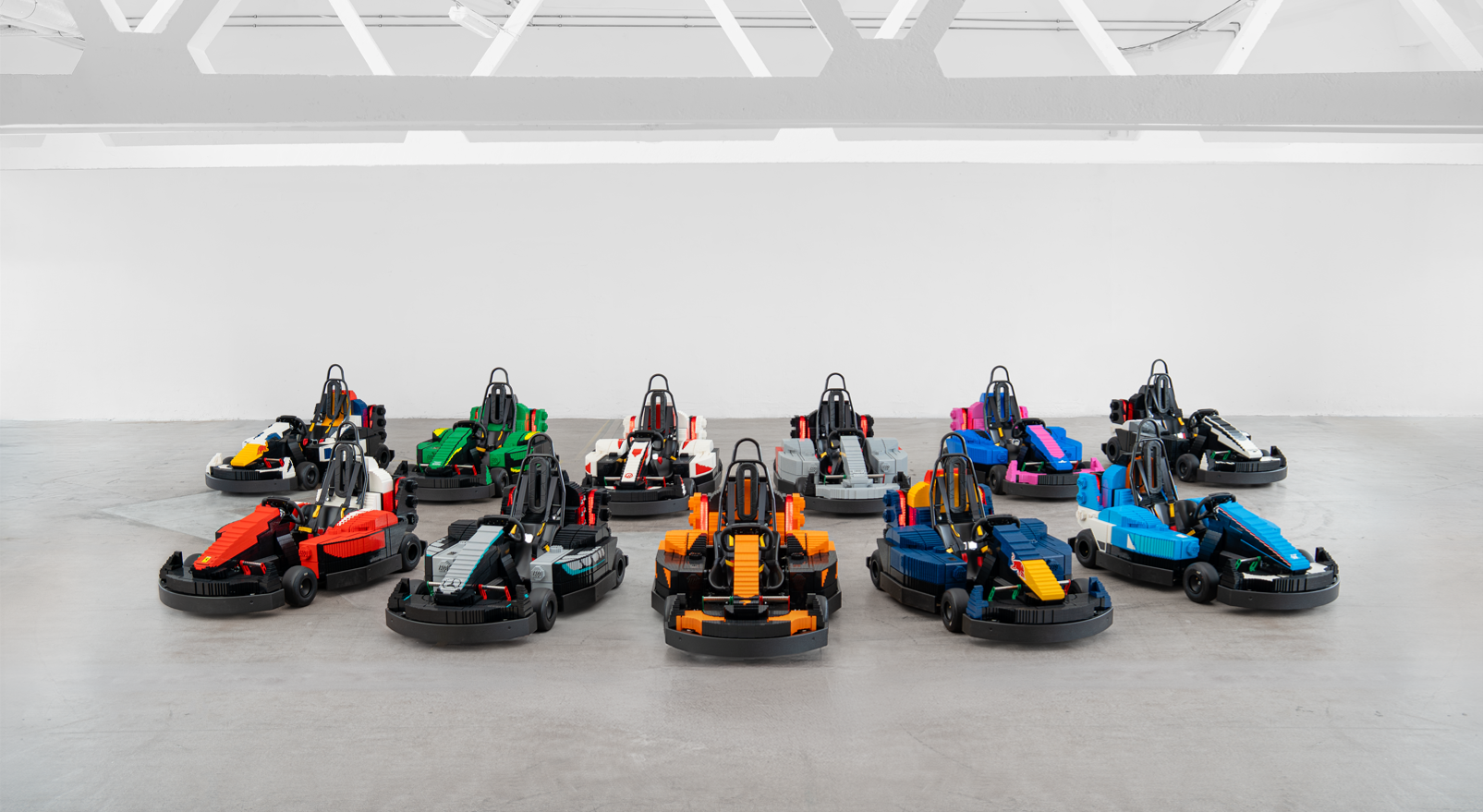 LEGO-built Formula 1 minicars displayed indoors before the British Grand Prix drivers' parade.