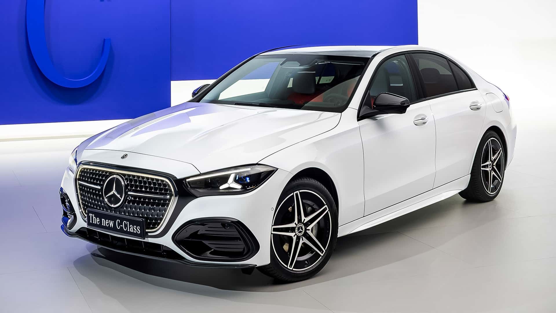 Official Mercedes-Benz image of the refreshed C-Class sedan driving on a road.