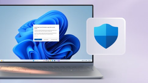 Official Microsoft Windows security image showing a Defender shield beside a Windows laptop.