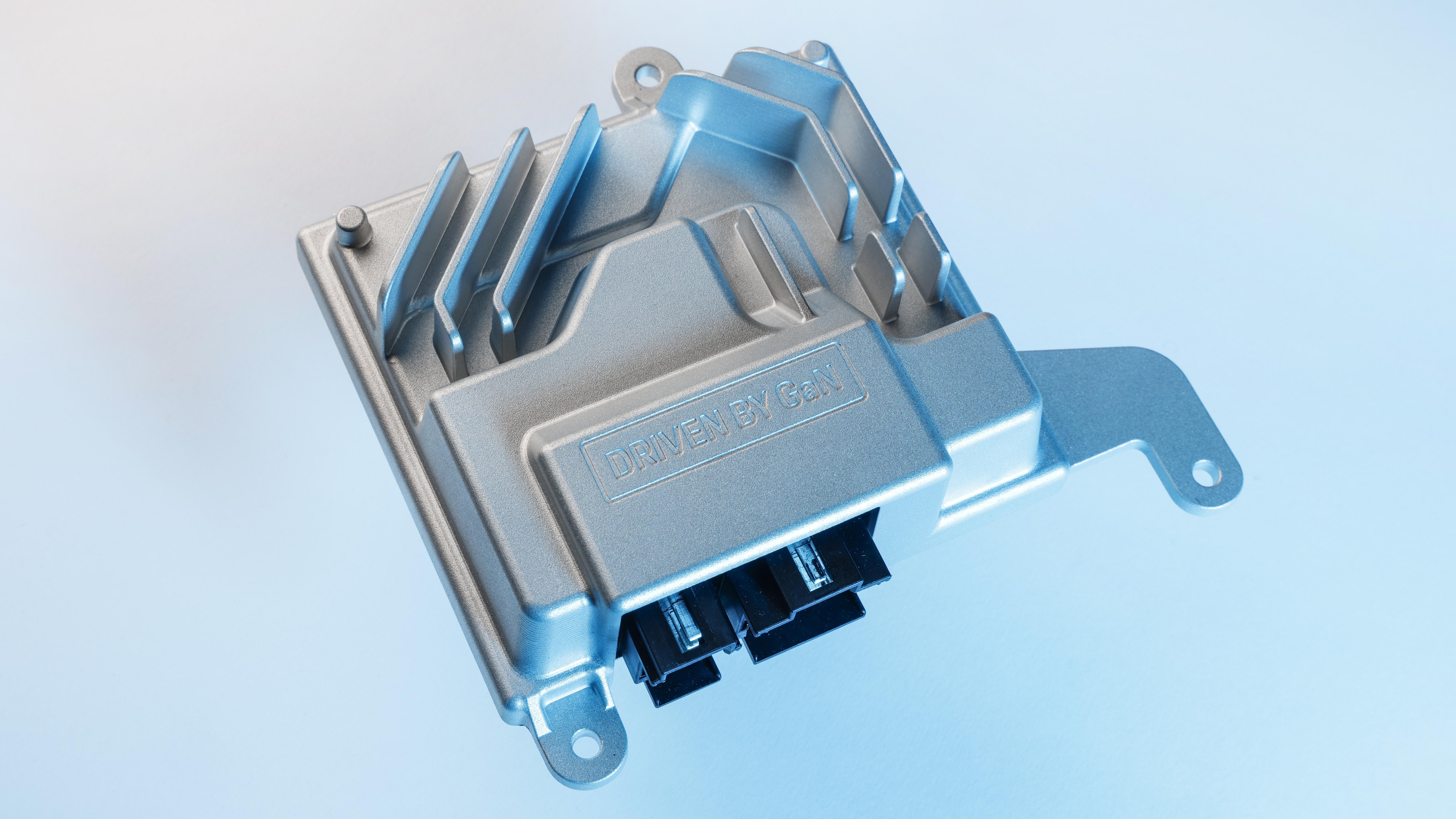 Official Porsche image of the compact gallium-nitride amplifier developed for its Burmester high-end automotive audio system.