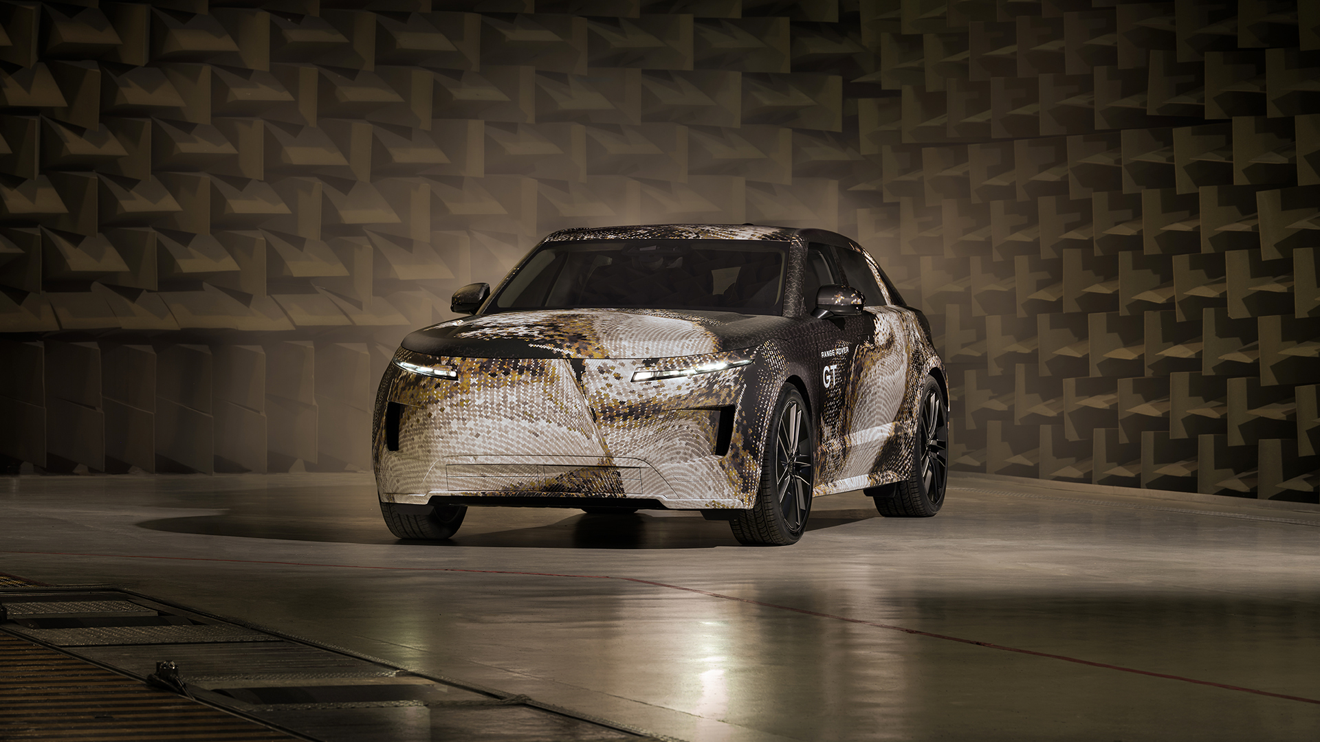 Camouflaged Range Rover GT prototype shown from the front three-quarter angle.