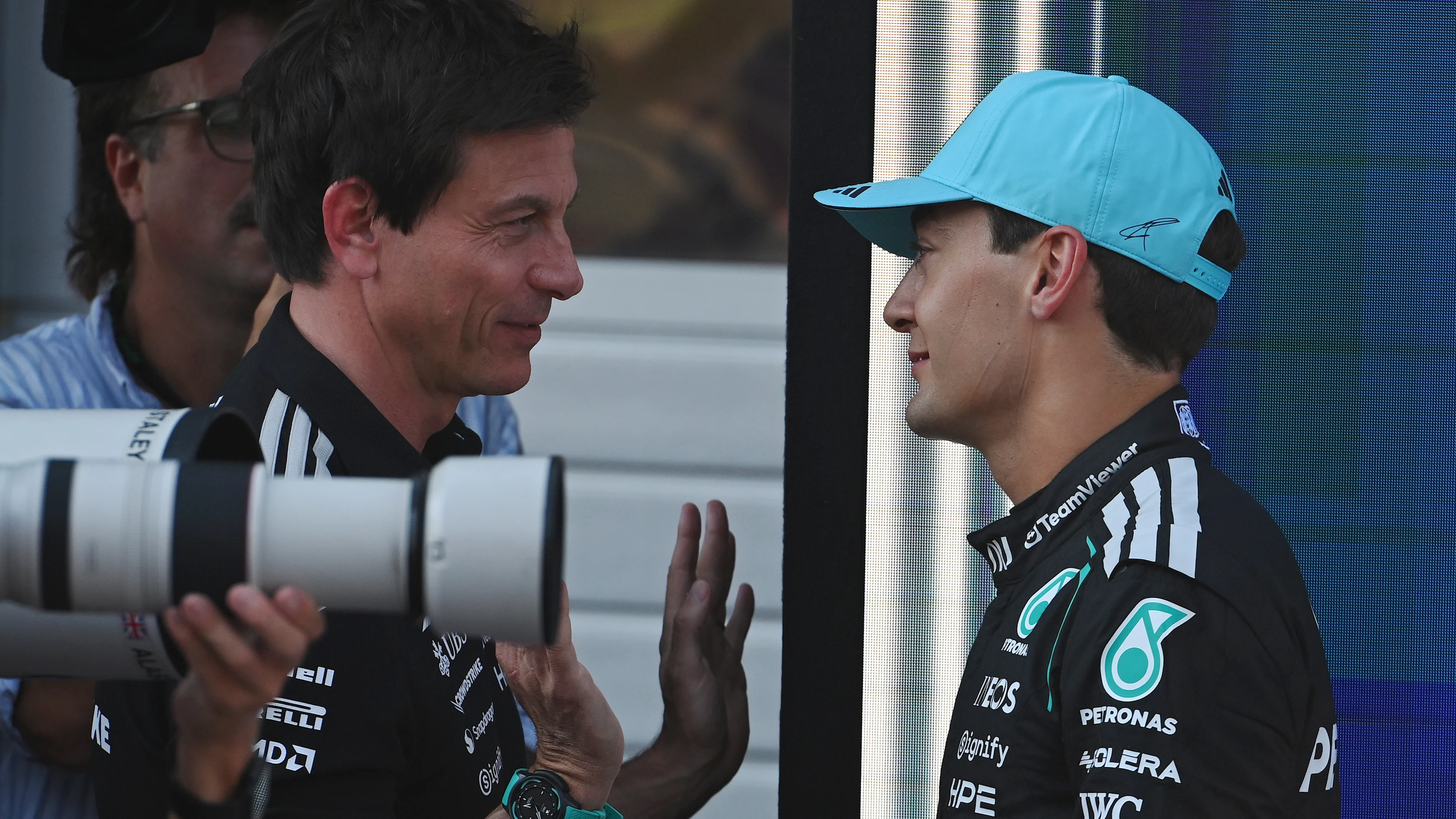 George Russell speaking with Toto Wolff during a Mercedes Formula 1 race weekend.
