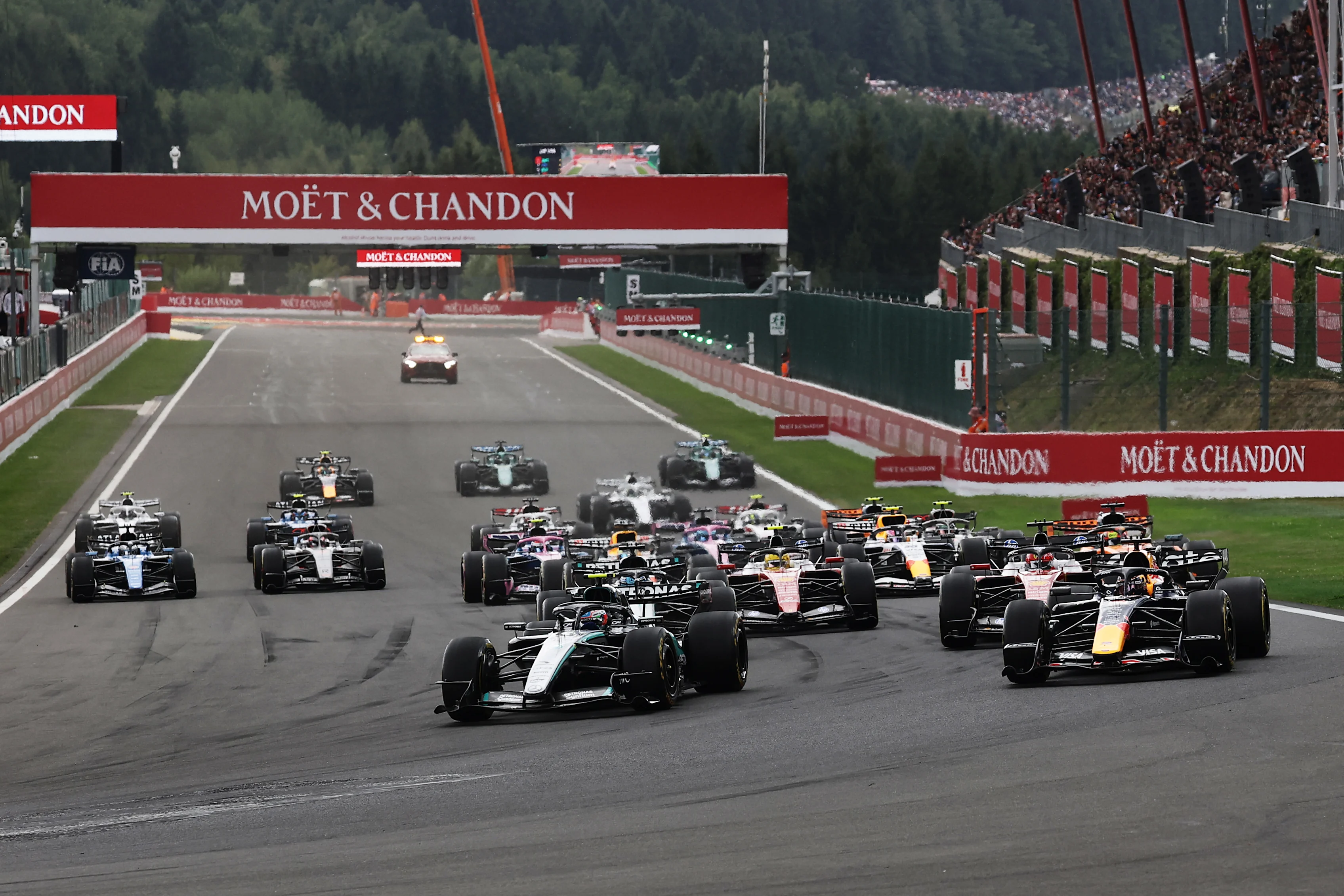 Formula 1 cars accelerate away at the start of the Belgian Grand Prix at Spa-Francorchamps.