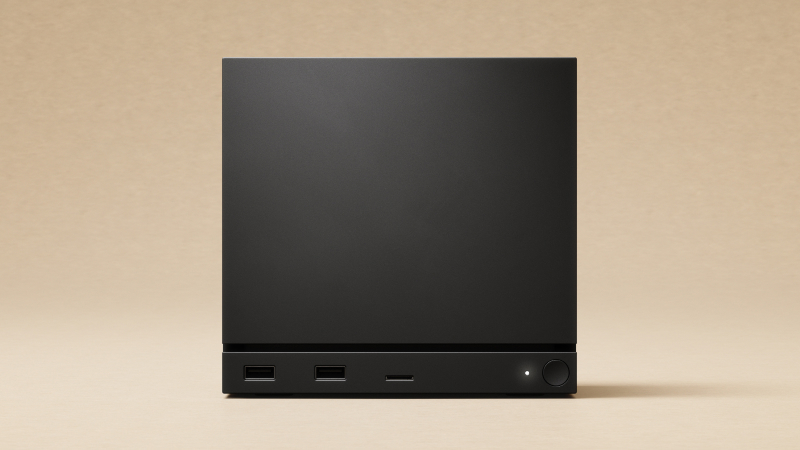 Official Valve image of the compact black Steam Machine cube for living room PC gaming.