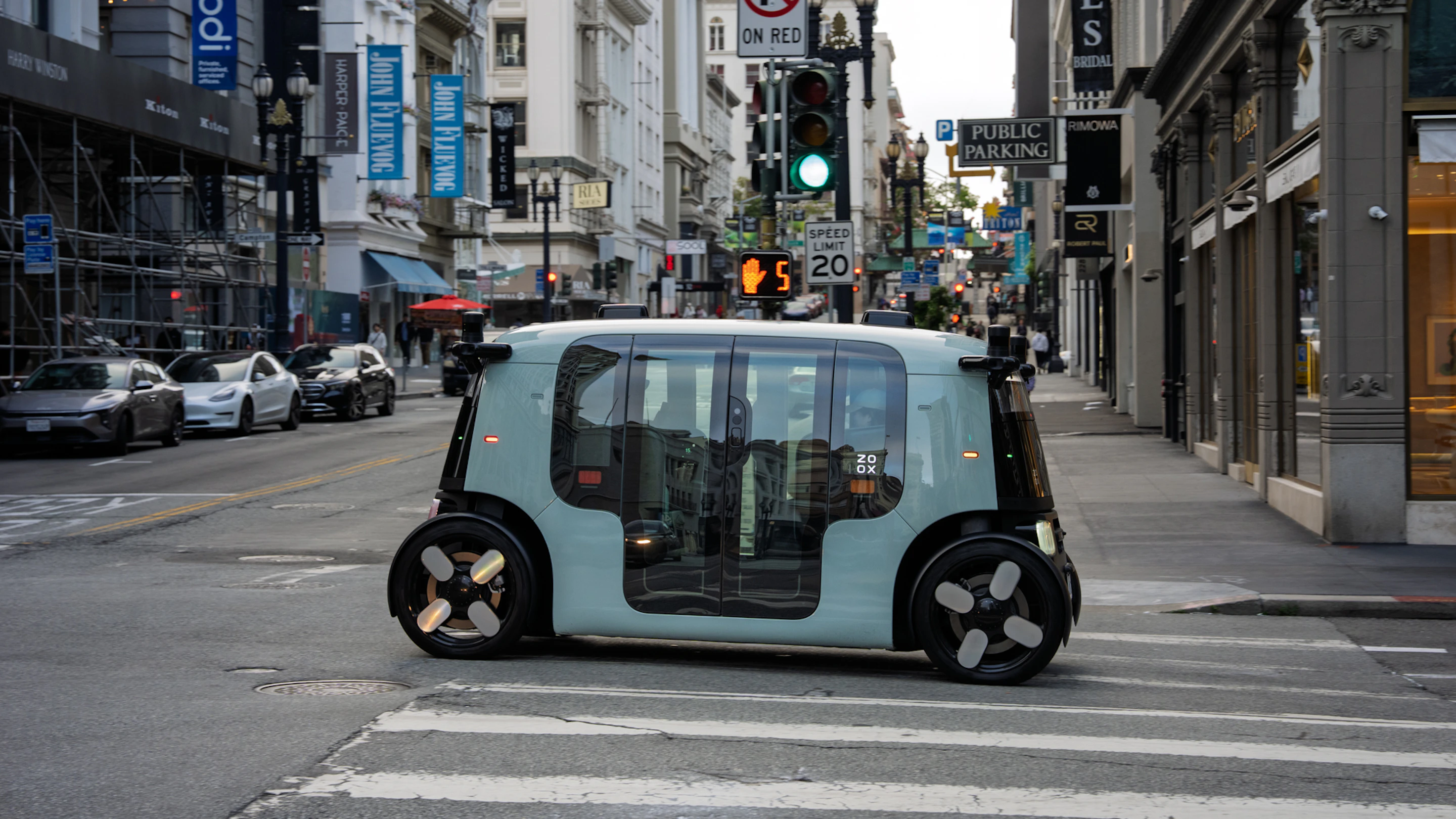 Zoox purpose-built robotaxi driving in Las Vegas traffic.